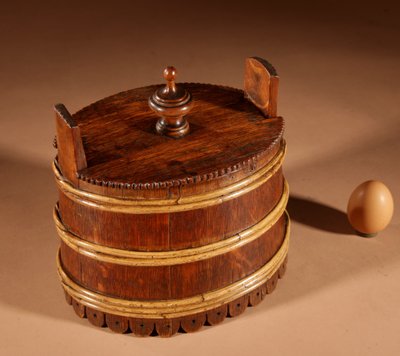 An oval oak butter pot.