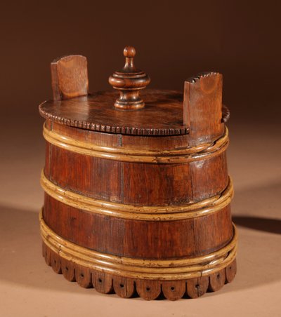 An oval oak butter pot.