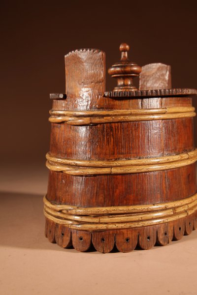 An oval oak butter pot.