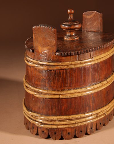 An oval oak butter pot.