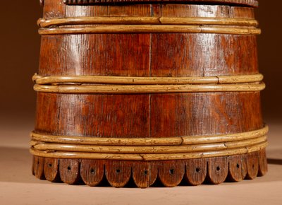 An oval oak butter pot.