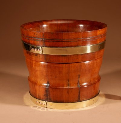 A large Dutch brass and turned teak planter/wine cooler, circa 1900
