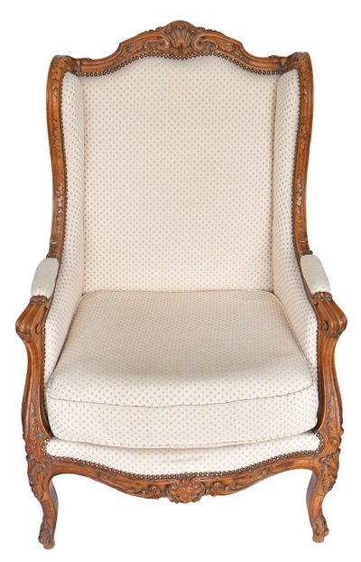 Fauteuil bergère à oreilles de style Louis XV en bois richement sculpté