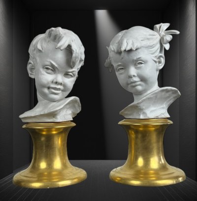 PAIR OF BISQUE CHILDREN'S BUSTS SIGNED BRUNO MERLI ON PORCELAIN BASE
