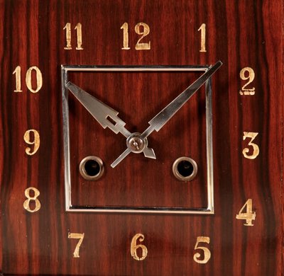  A very elegant mantel clock typical of the Amsterdam Art Deco school in oak and ebony from