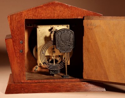  A very elegant mantel clock typical of the Amsterdam Art Deco school in oak and ebony from