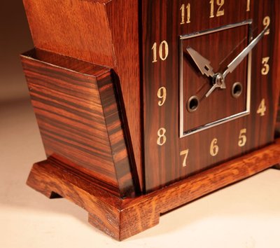 A very elegant mantel clock typical of the Amsterdam Art Deco school in oak and ebony from