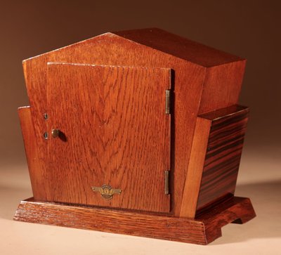  A very elegant mantel clock typical of the Amsterdam Art Deco school in oak and ebony from