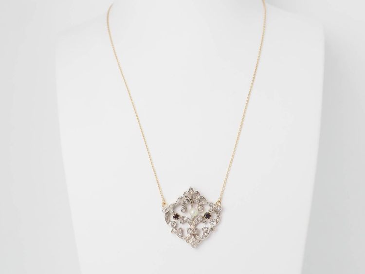 Collier volutes en or jaune et argent, grenat diamants et perle
