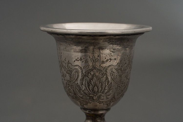 Pair of 19th century Persian silver candlesticks, engraved with bird design, hallmarked 84