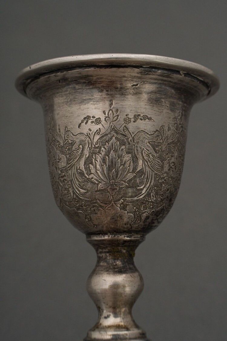 Pair of 19th century Persian silver candlesticks, engraved with bird design, hallmarked 84