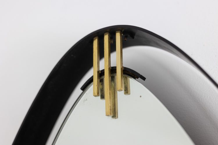 Lacquered and patinated brass mirror, ovoid shape. 1950s/60s. LS6351736M