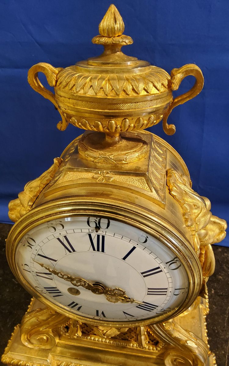 Louis XVI style clock in gilded bronzes with Lions' heads Greek decor 19th century