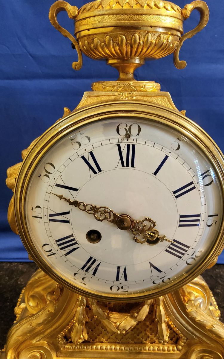 Louis XVI style clock in gilded bronzes with Lions' heads Greek decor 19th century