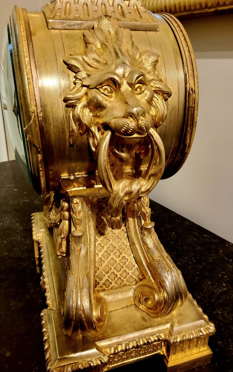 Louis XVI style clock in gilded bronzes with Lions' heads Greek decor 19th century