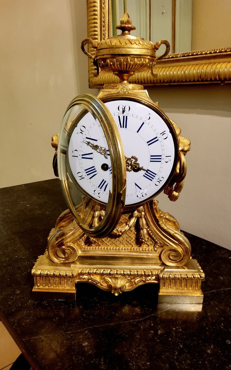 Louis XVI style clock in gilded bronzes with Lions' heads Greek decor 19th century