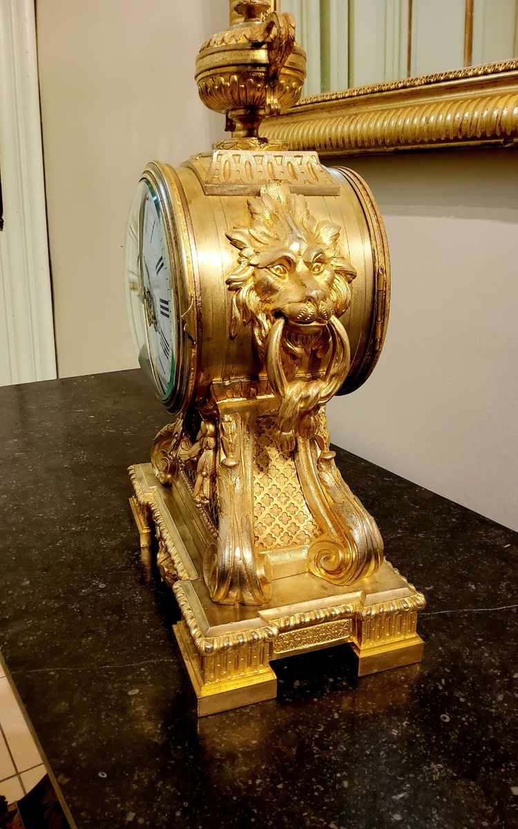 Louis XVI style clock in gilded bronzes with Lions' heads Greek decor 19th century