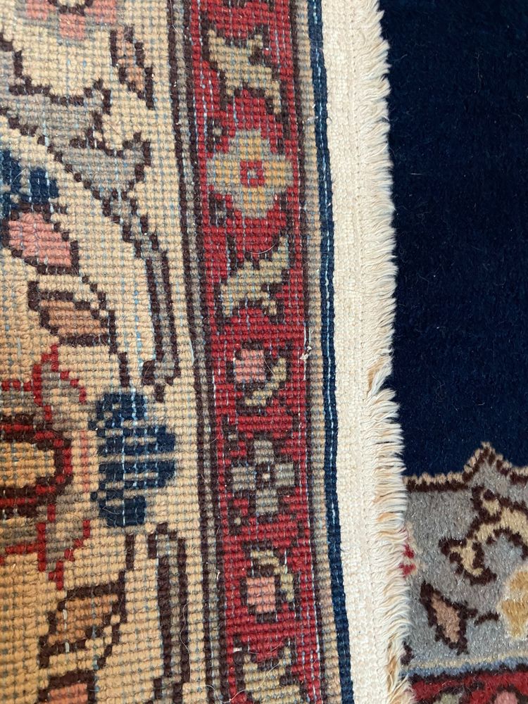 NAIN hand-knotted wool oriental rug with central medallion on midnight blue background