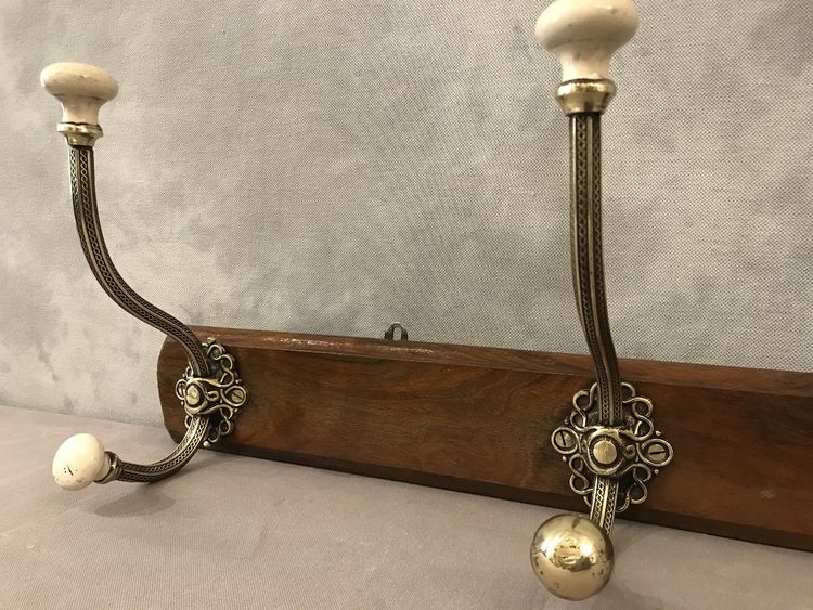 Late 19th century brass and ceramic coat rack and coat hooks on wood