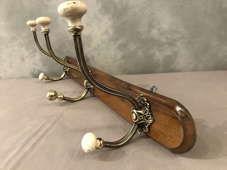 Late 19th century brass and ceramic coat rack and coat hooks on wood