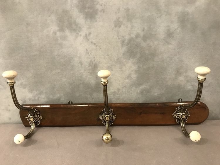Late 19th century brass and ceramic coat rack and coat hooks on wood