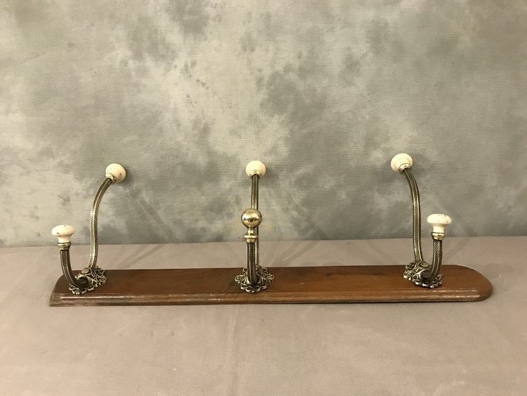 Late 19th century brass and ceramic coat rack and coat hooks on wood