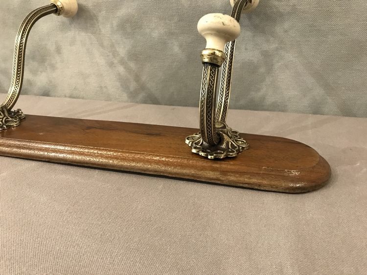 Late 19th century brass and ceramic coat rack and coat hooks on wood