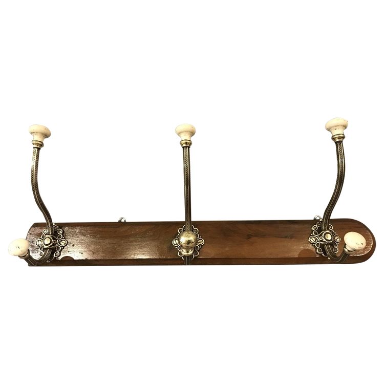 Late 19th century brass and ceramic coat rack and coat hooks on wood