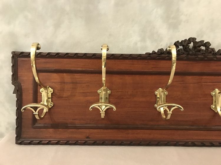 Set of 6 19th century bronze coat hooks on wood