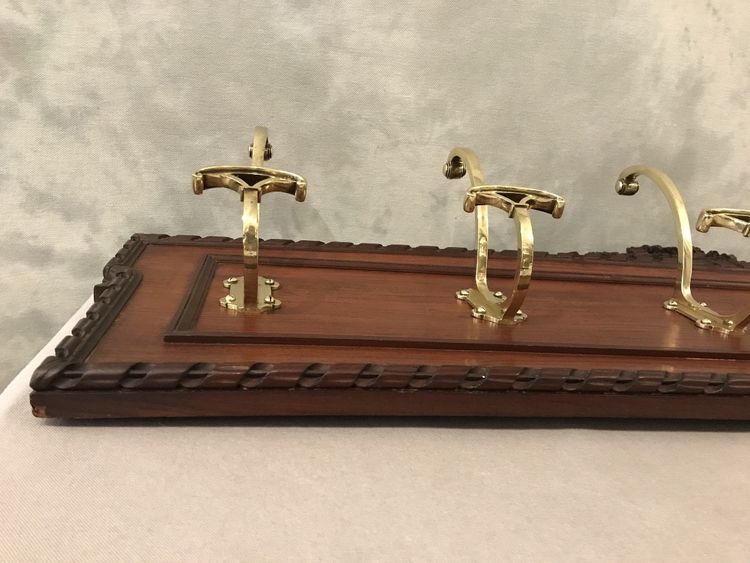 Set of 6 19th century bronze coat hooks on wood