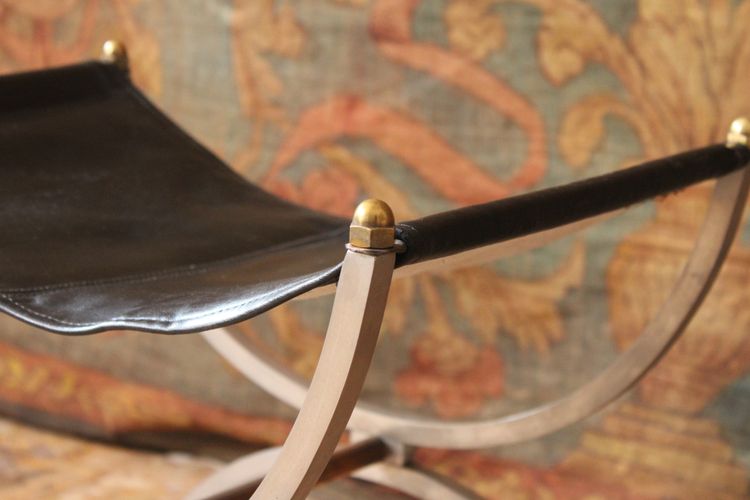 Curule stool seat in polished wrought iron with brass ornamentation, 20th century