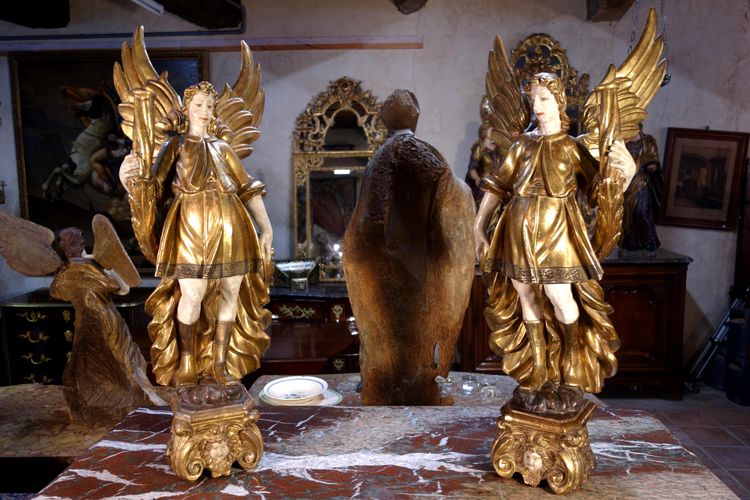 Large pair of gilded wooden torch-bearing angels, 18th century