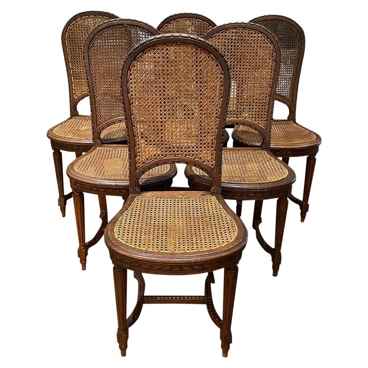 Six chaises de style Louis XVI, en chêne. Assises et dossiers cannés. Début XXe