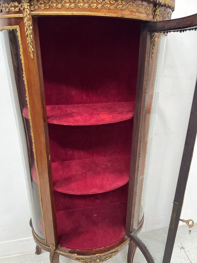 Napoleon III-style display cabinet in mahogany and veneer It opens with a curved glass door on the front.