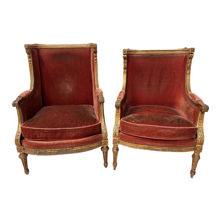 Deux bergères a oreilles de style Louis XVI en bois doré XX siècle