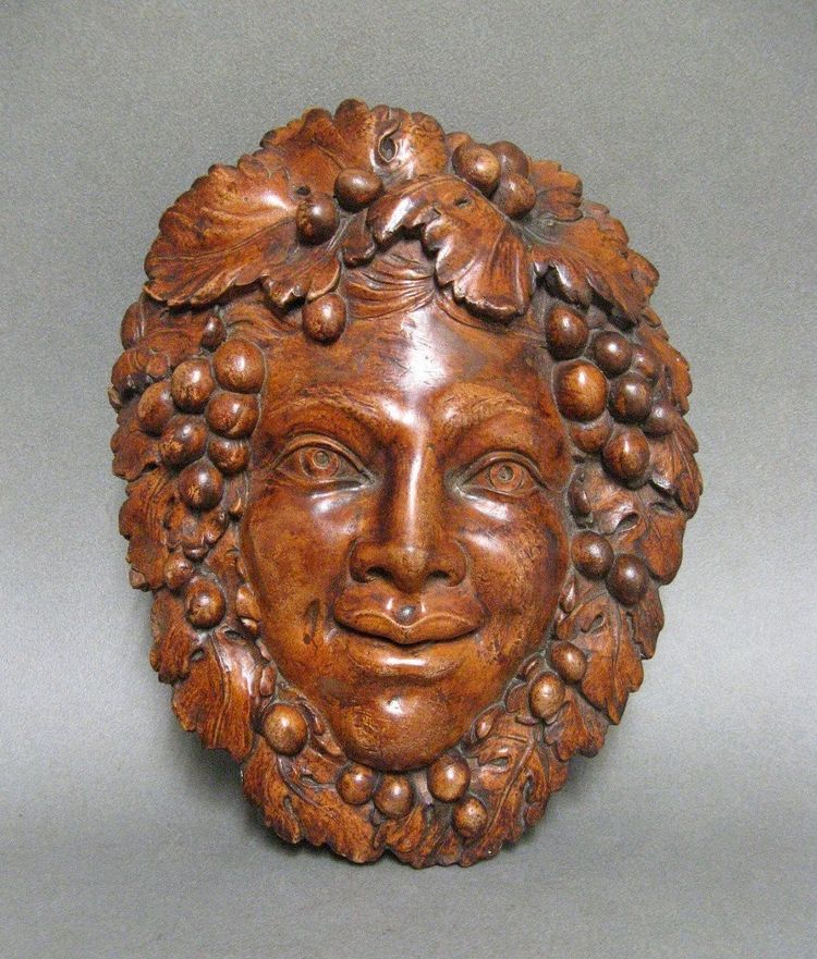 Bacchus head in glazed terracotta.