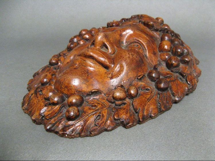 Bacchus head in glazed terracotta.