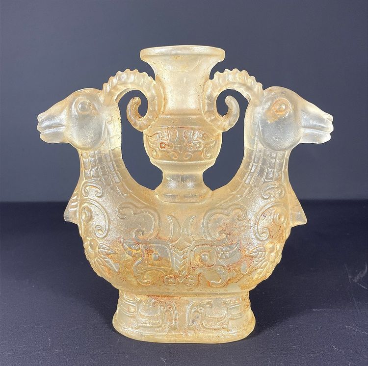China, Qing Dynasty, early 19th century, candlestick in the form of a small vase surrounded by two rams.