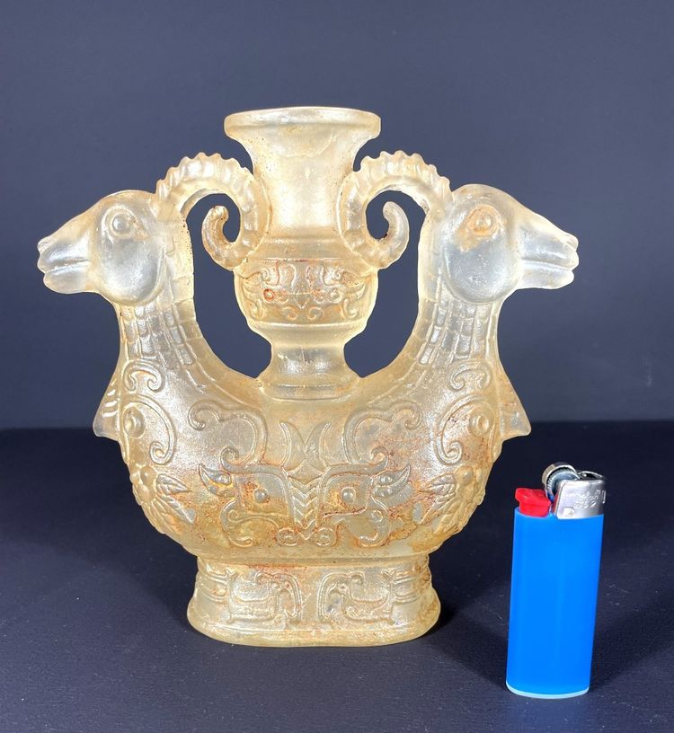 China, Qing Dynasty, early 19th century, candlestick in the form of a small vase surrounded by two rams.