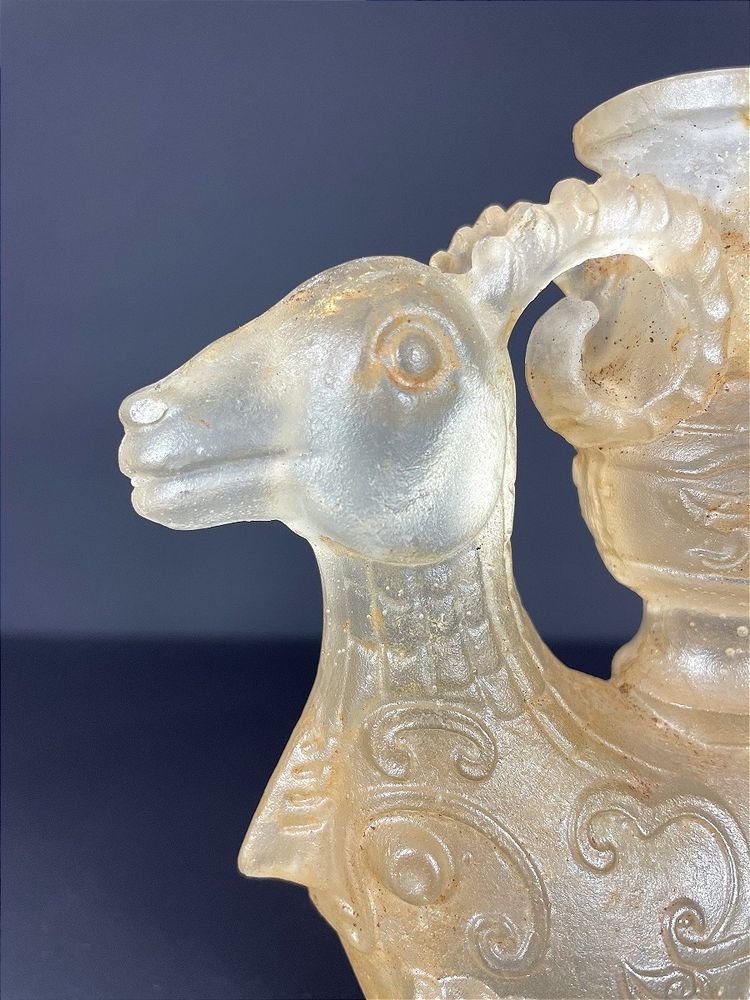 China, Qing Dynasty, early 19th century, candlestick in the form of a small vase surrounded by two rams.