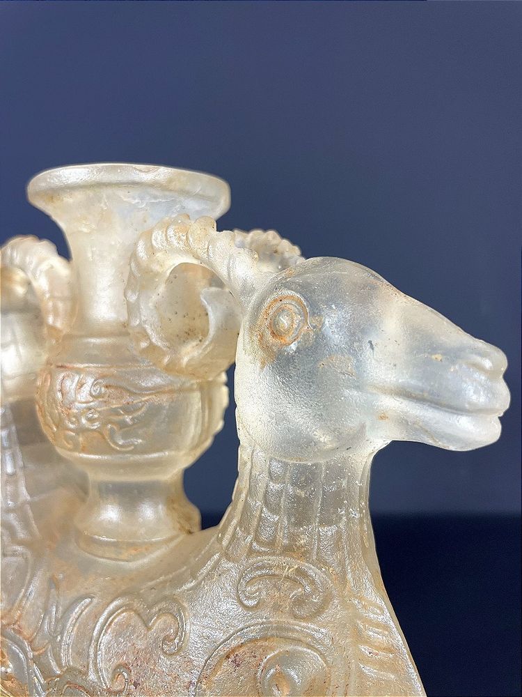 China, Qing Dynasty, early 19th century, candlestick in the form of a small vase surrounded by two rams.