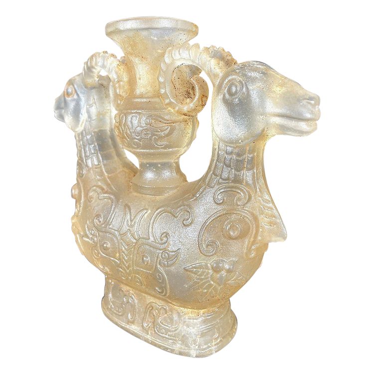 China, Qing Dynasty, early 19th century, candlestick in the form of a small vase surrounded by two rams.