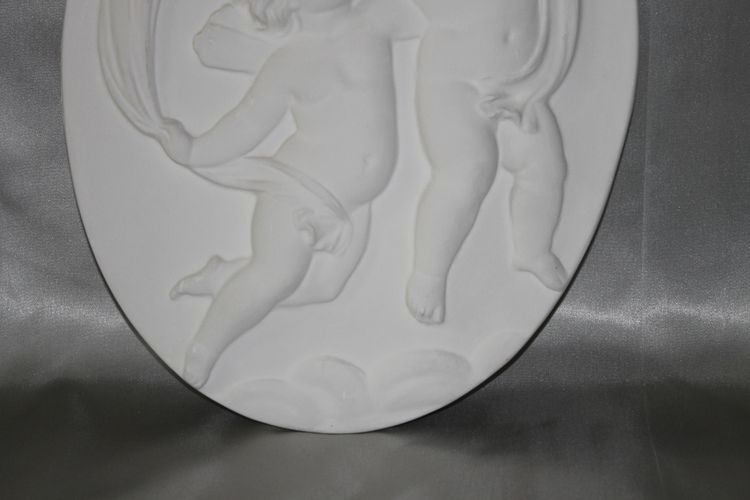 Pair of plaster bas-reliefs decorated with cherubs in the Louis XVI style, 20th century.