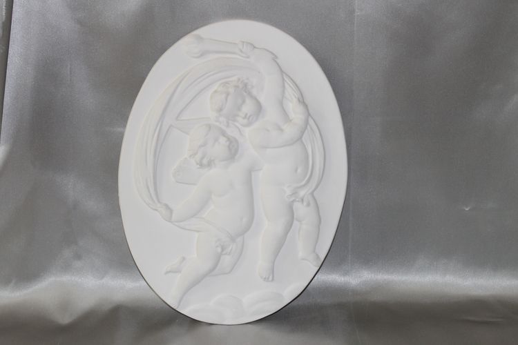 Pair of plaster bas-reliefs decorated with cherubs in the Louis XVI style, 20th century.