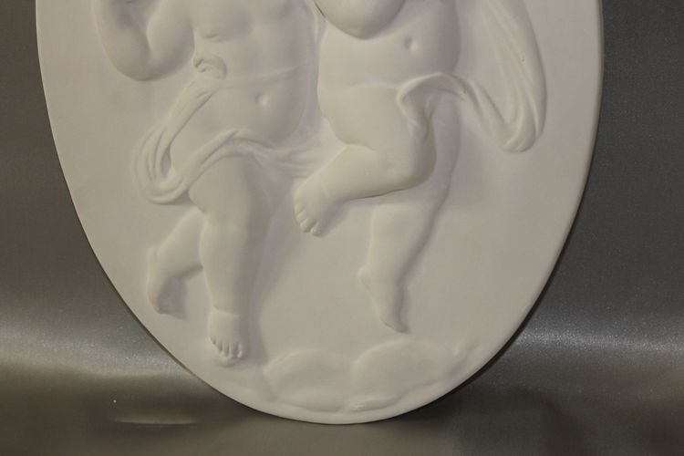 Pair of plaster bas-reliefs decorated with cherubs in the Louis XVI style, 20th century.