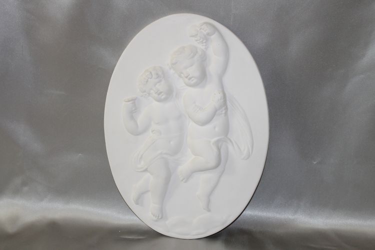 Pair of plaster bas-reliefs decorated with cherubs in the Louis XVI style, 20th century.