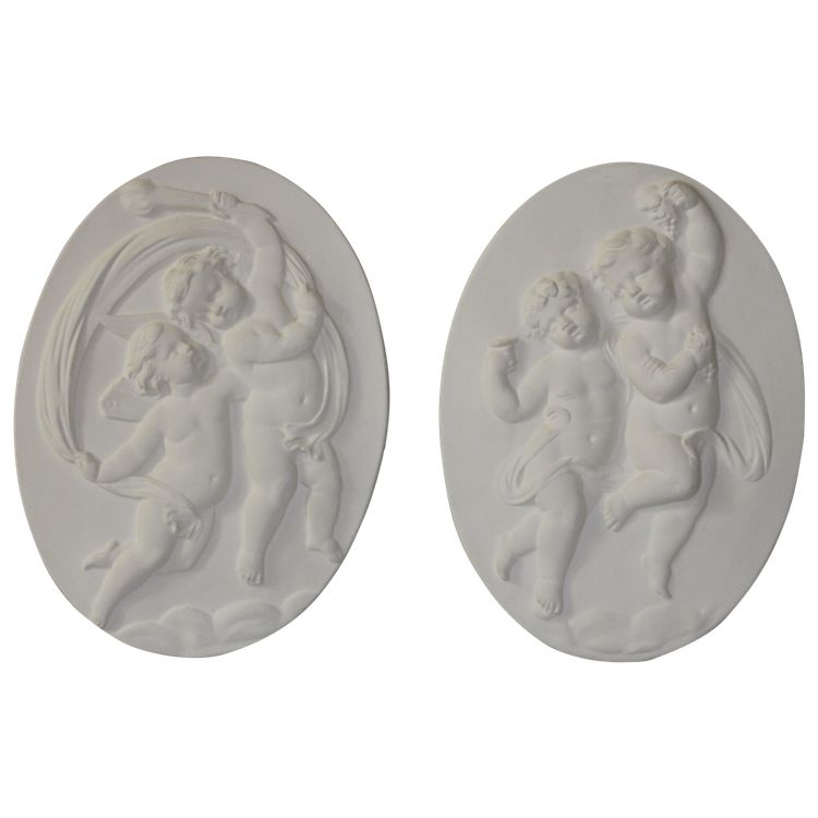 Pair of plaster bas-reliefs decorated with cherubs in the Louis XVI style, 20th century.