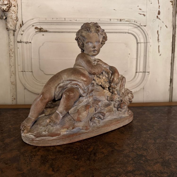 Terracotta statue representing Bacchus as a child on a barrel