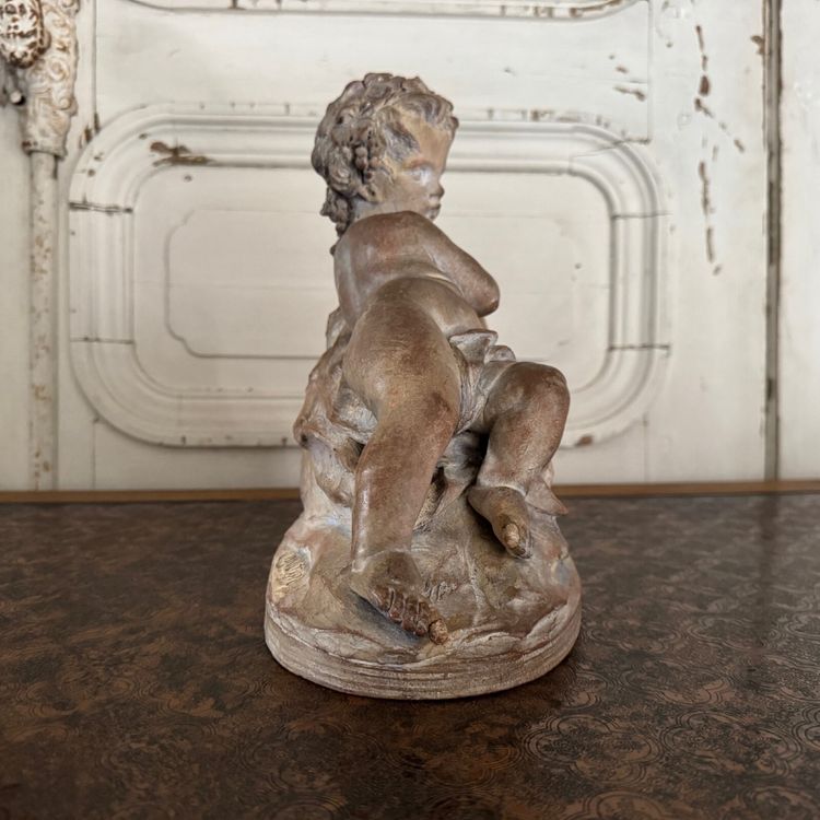 Terracotta statue representing Bacchus as a child on a barrel