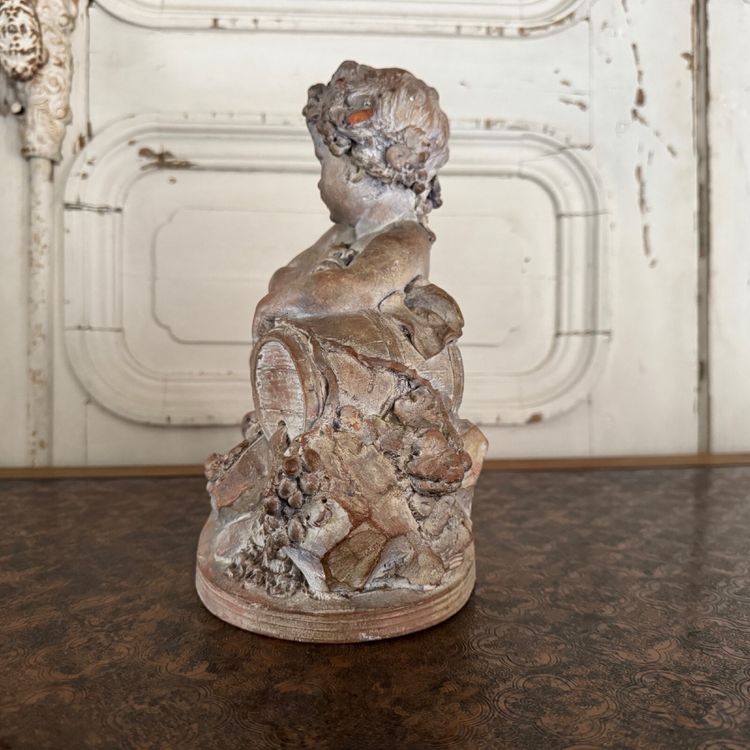 Terracotta statue representing Bacchus as a child on a barrel